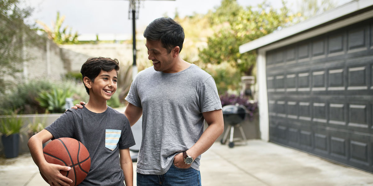 A father and son talk after shooting hoops together