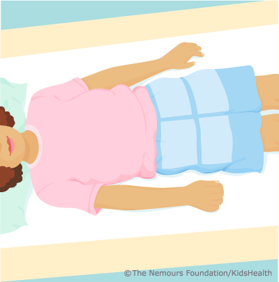 child lying on x-ray table with markers over pelvis area